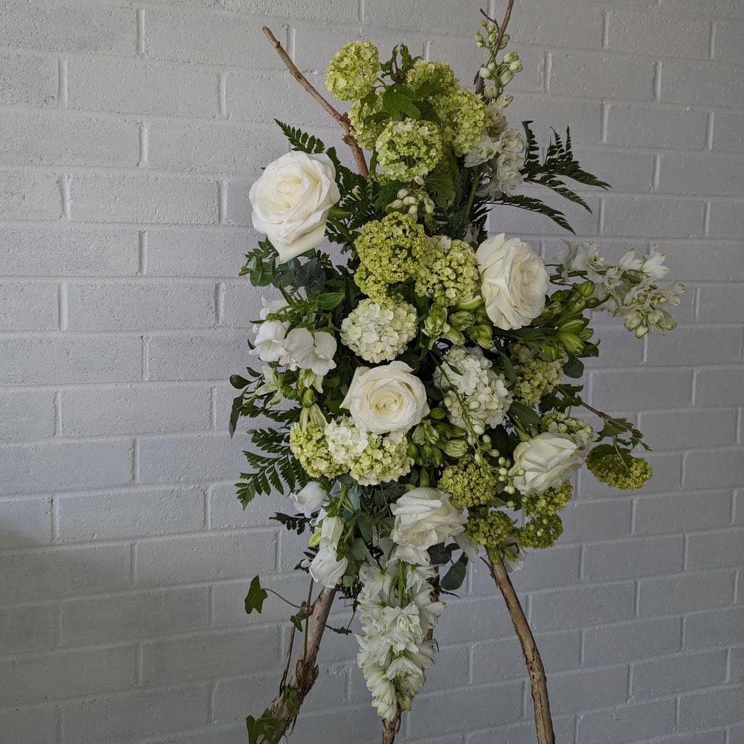 Green and white standing funeral spray