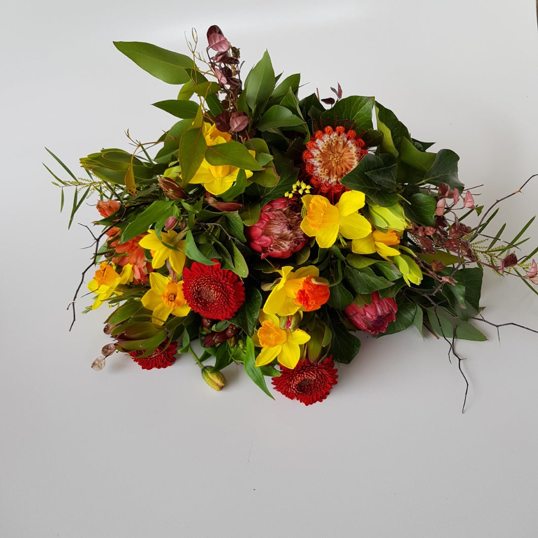 Bright bouquet with daffodils, gerbera & protea