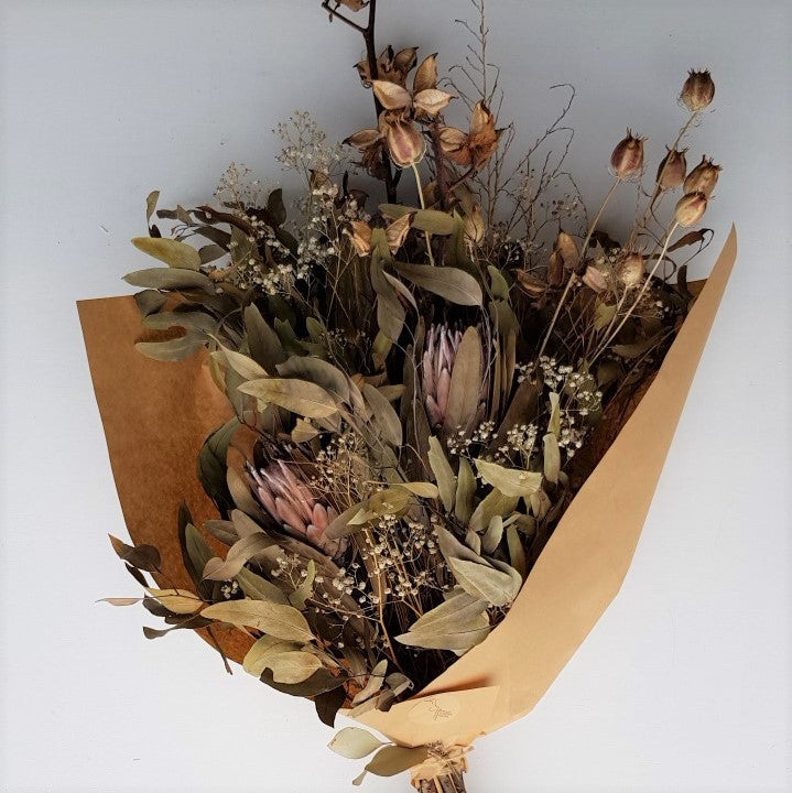 Dried bouquet with cotton husks, nigella pods, protea and eucalyptus.