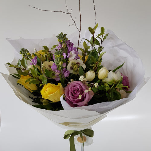 Pastel bouquet early spring with roses, tulips, hellebore, and stock